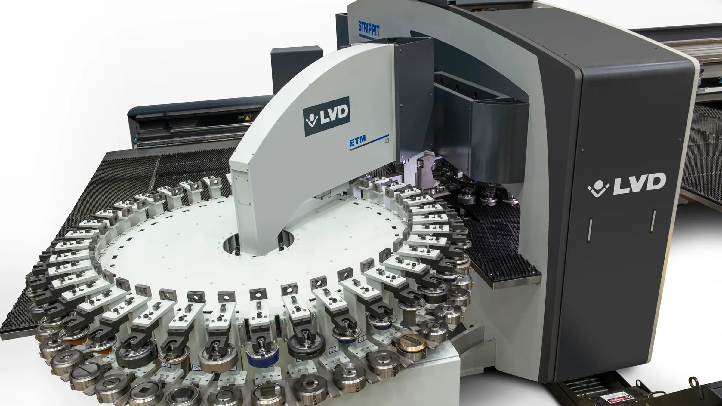 A CNC turret punch press punching a grid of holes in a steel sheet