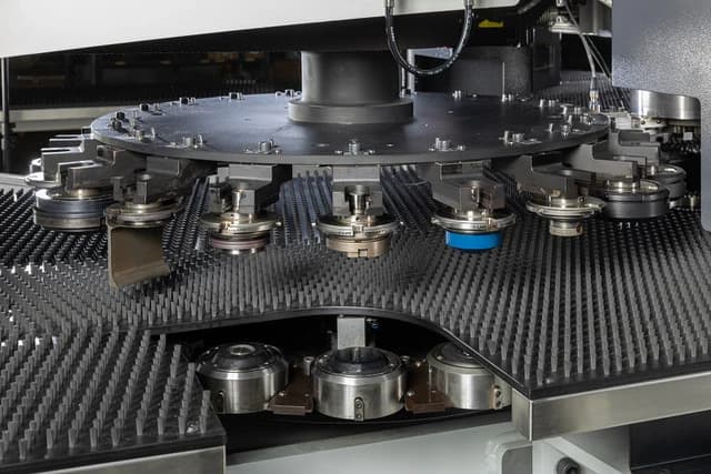 The indexable tool carousel above the brush table, loaded with punching tools