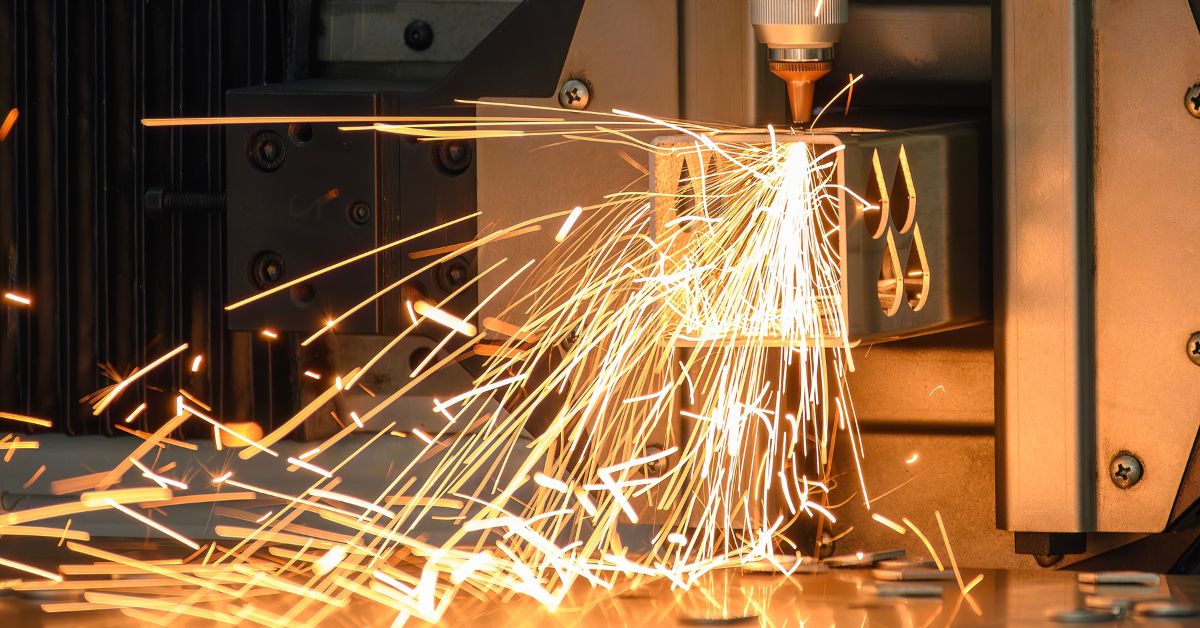 Close up scene the fiber laser cutting machine cut the square shape stainless steel tube with sparkling light. The hi-technology sheet metal manufacturing process by laser cutting machine.